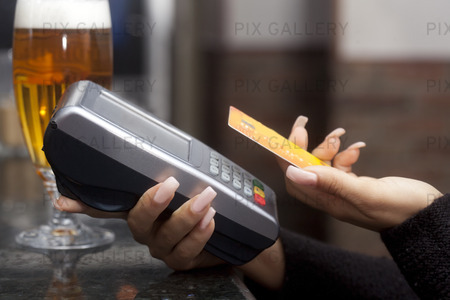 Woman Pay with credit card in a bar