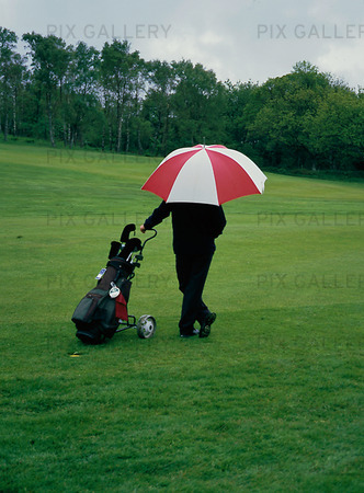 Golfspelare med paraply