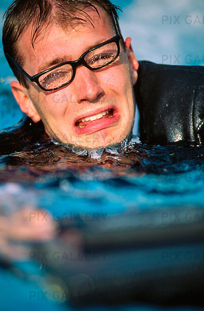 Man in pool with clothes on