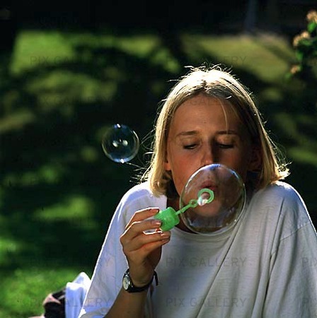 Girl blowing bubble blower