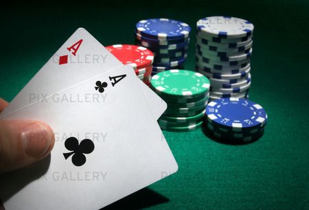 Looking at pocket aces during a poker game.