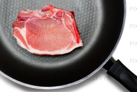 Fry pan isolated on a white background  with a pork steaks