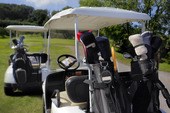 Two golf cart with clubs ready to go