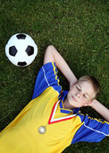 Boy with football and a medal